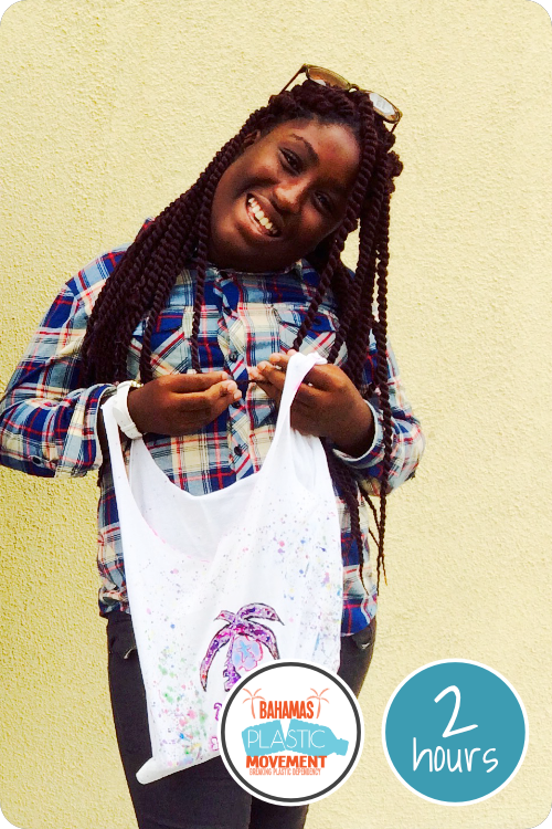 A young girl holds up a reusable bag that she made out of an old tshirt.