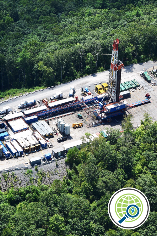 A fracking well pad with containers and equipment sits among trees.A fracking well pad with containers and equipment sits among trees.