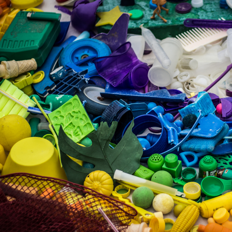 Collection of plastic waste items in a colorful mural