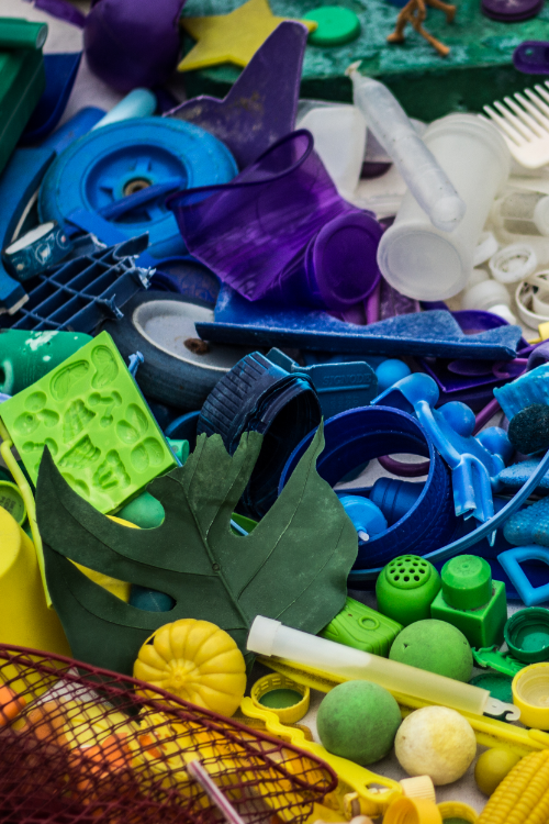 Assorted plastic debris objects arranged by color.