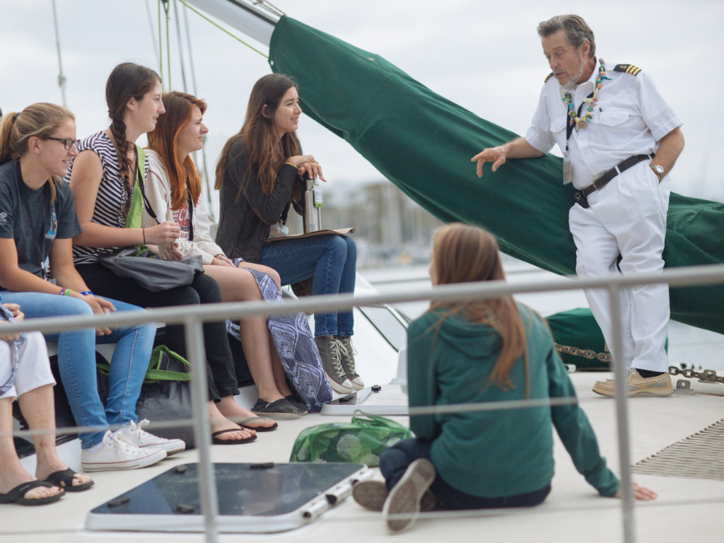 Captain Moore talking to students on the bow of his boat