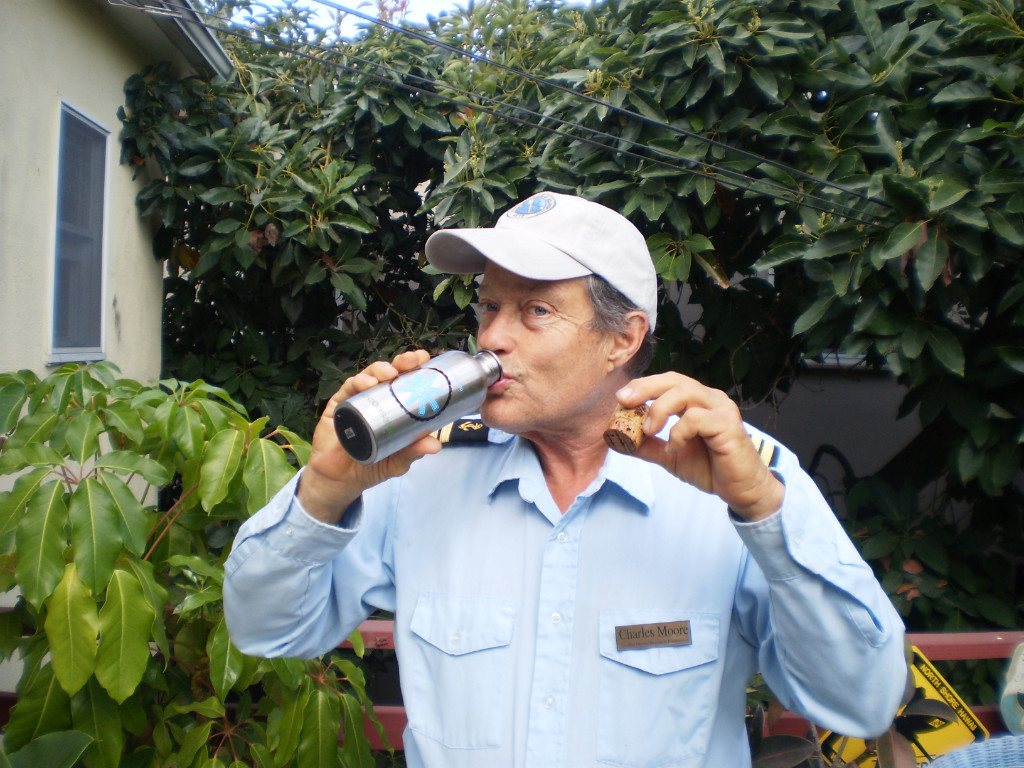 Captain Moore drinking out of a reusable bottle in his garden