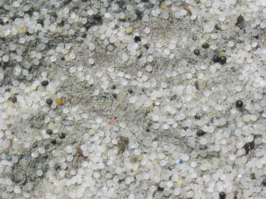Plastic preproduction pellets in the sand