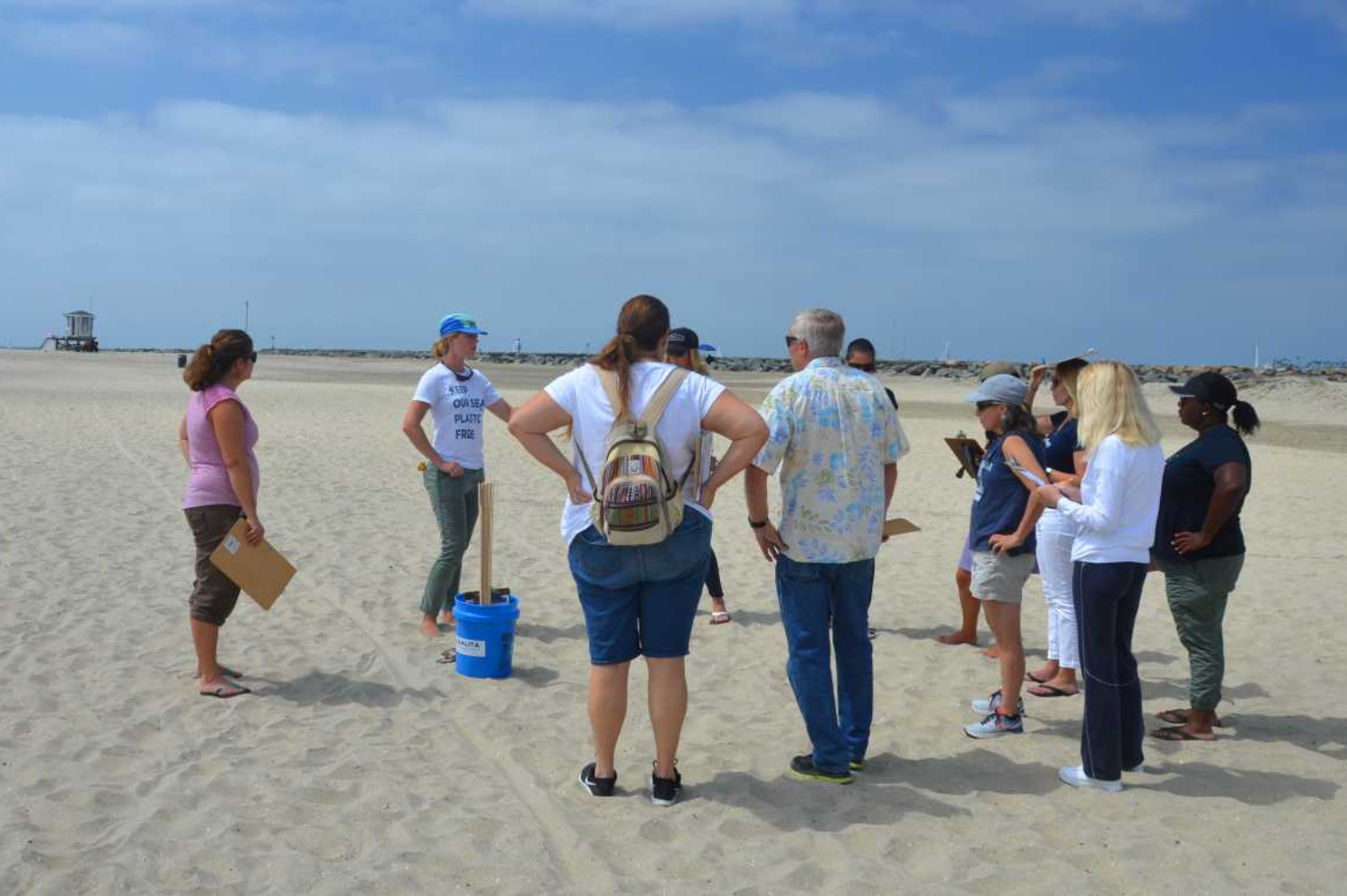 Educators at the beach for a workshop on microplastics in sand.