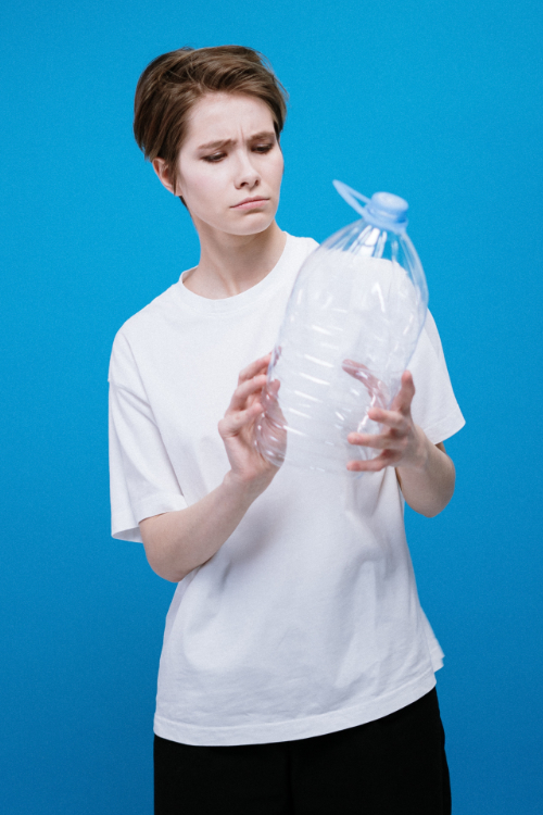 Lesson image card - Person holding a plastic jug and looking puzzled.