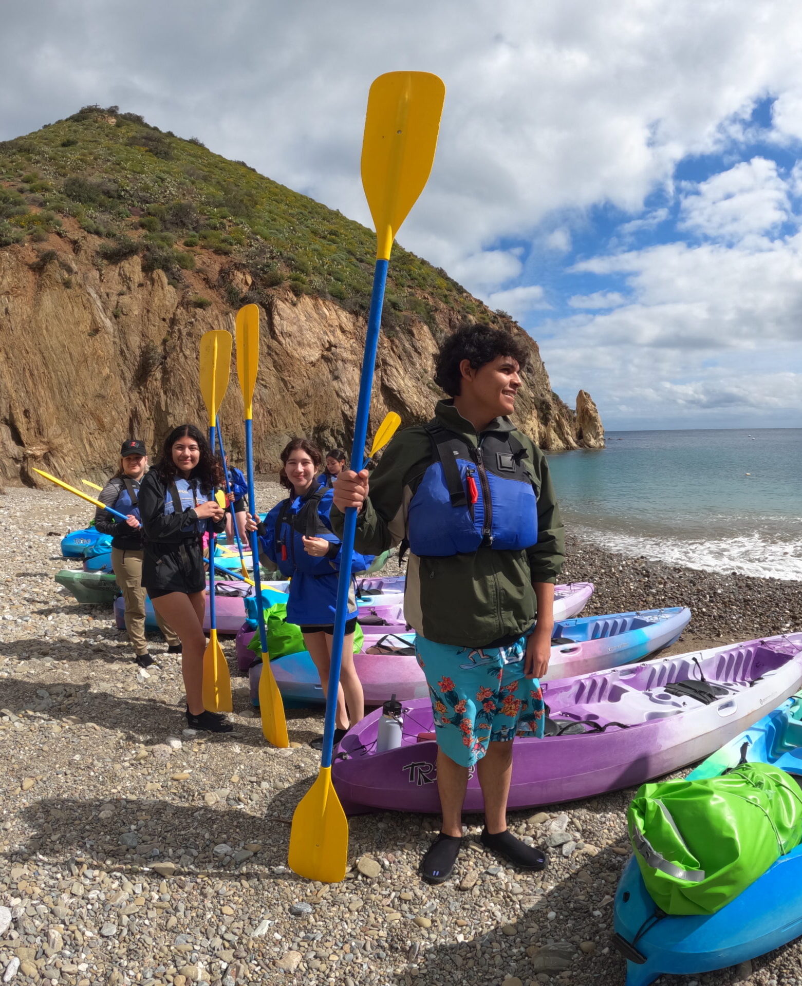 students on the beach getting ready to kayak during a field trip in California