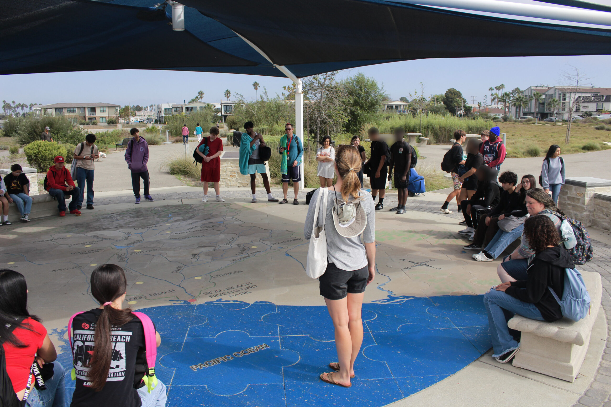 Educator and students talking at a watershed map.