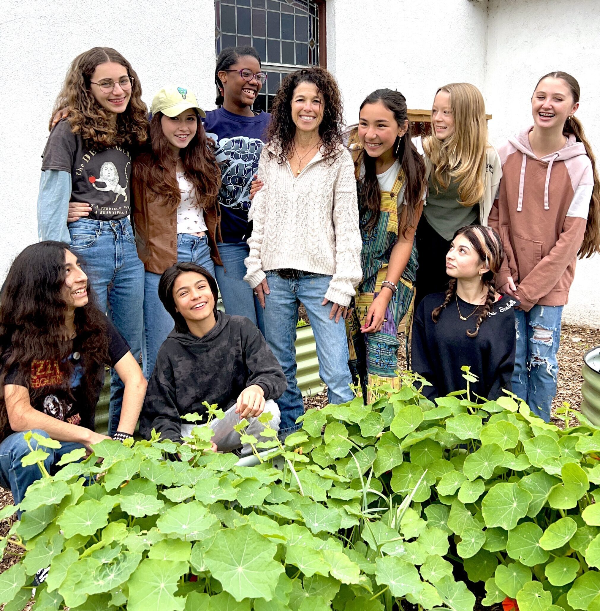 Mrs. McCarthy and students in the school garden