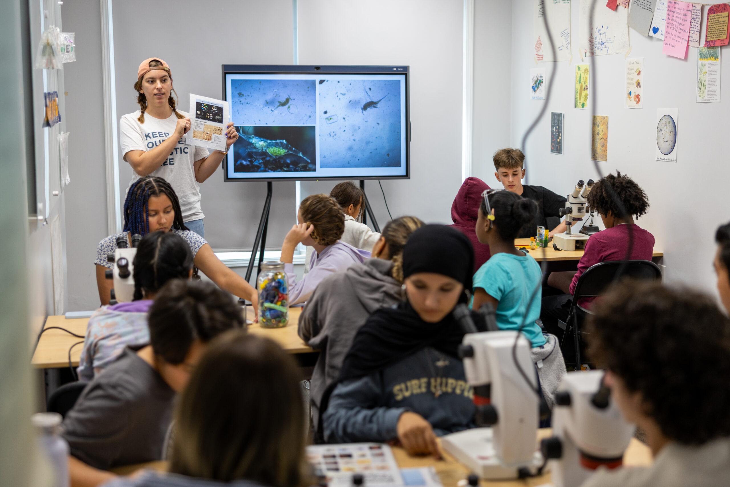 Student analyzing a water sample with a microscope.